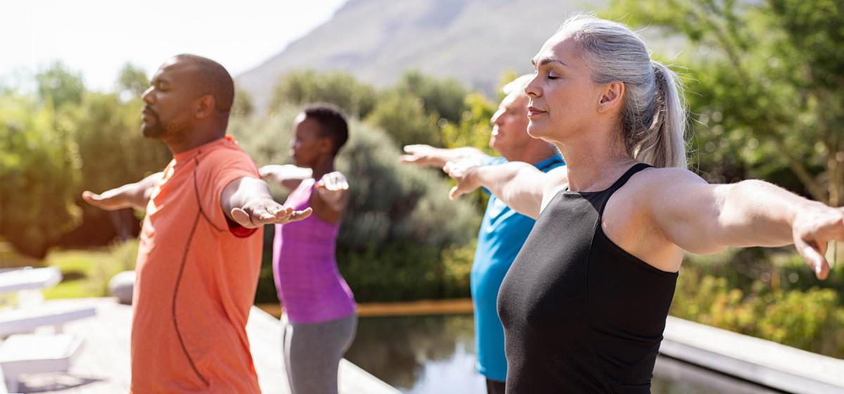 Group of people in yoga class outside