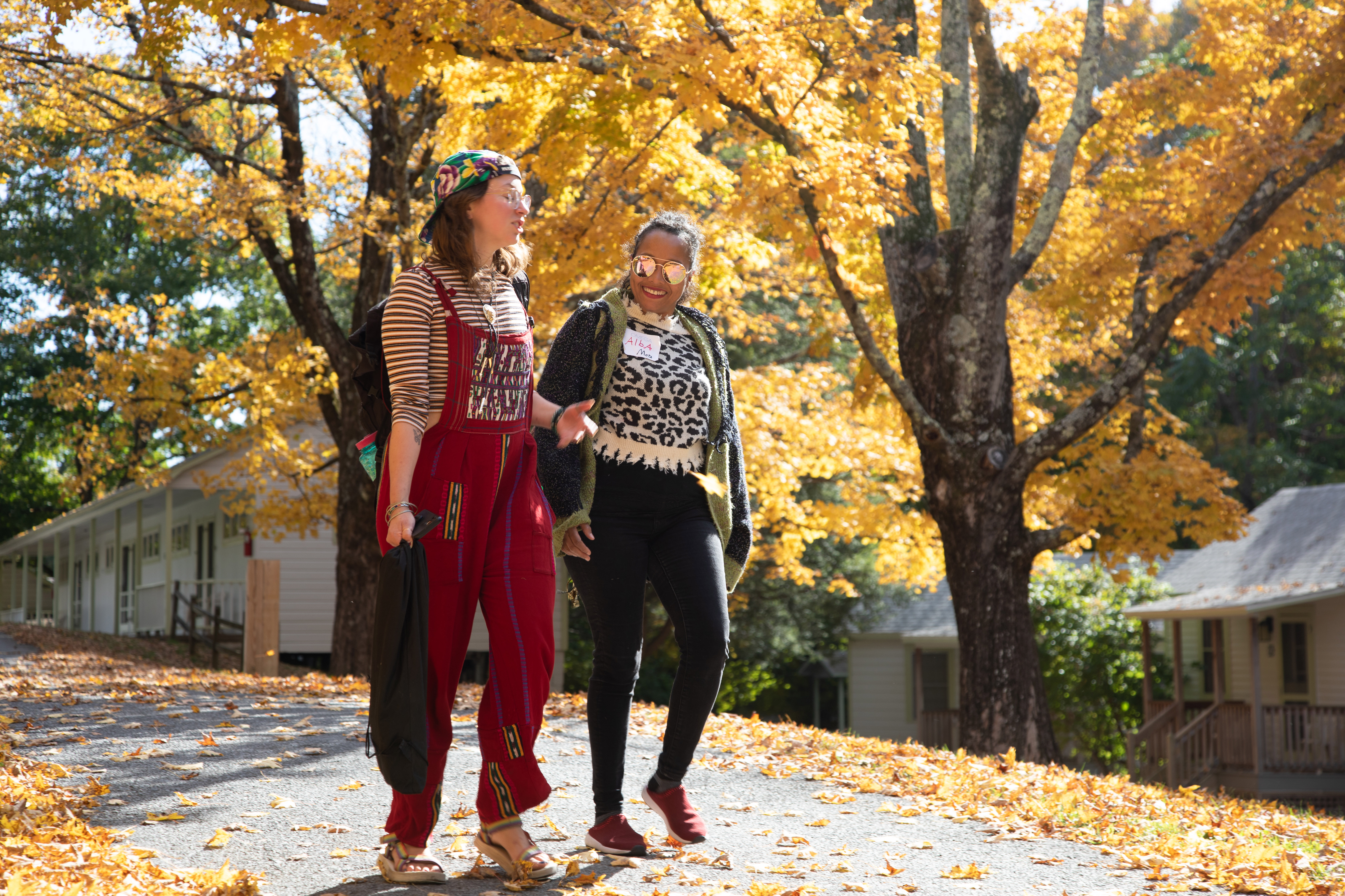Two people walking on campus in fall