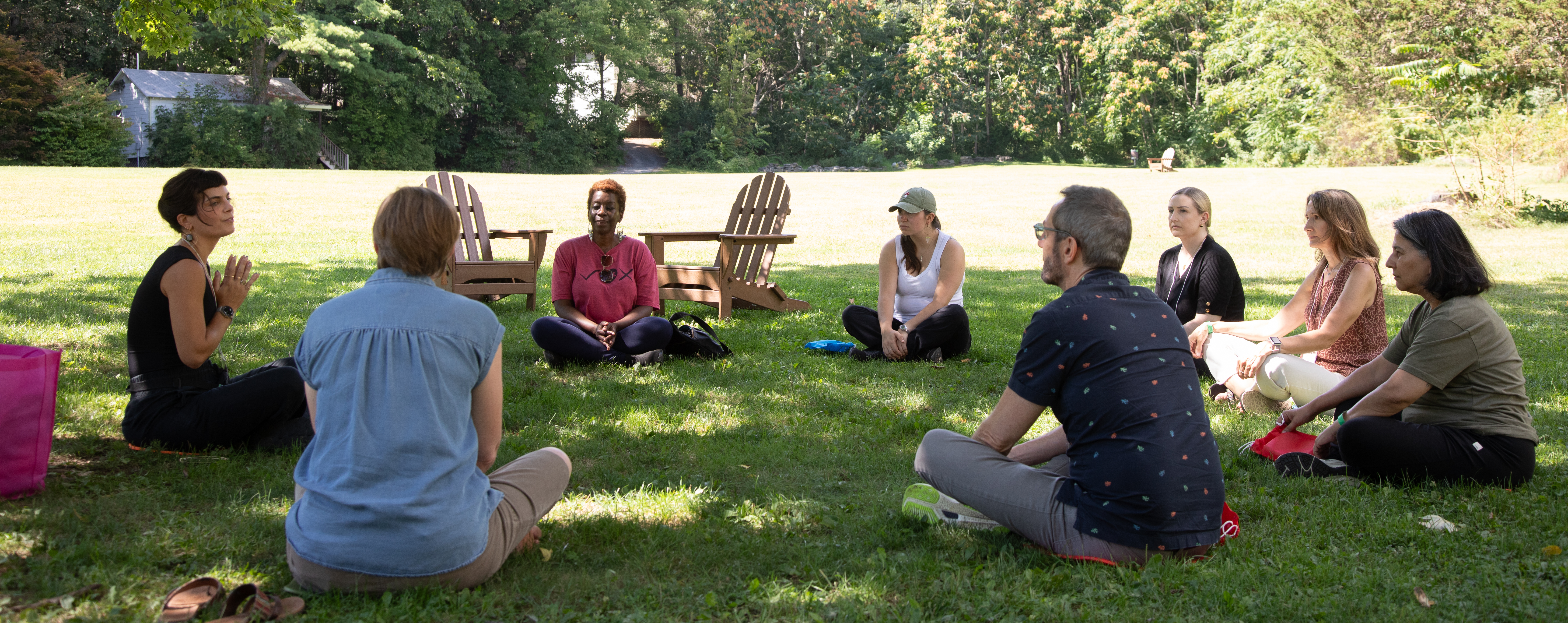 People sit in a circle outside