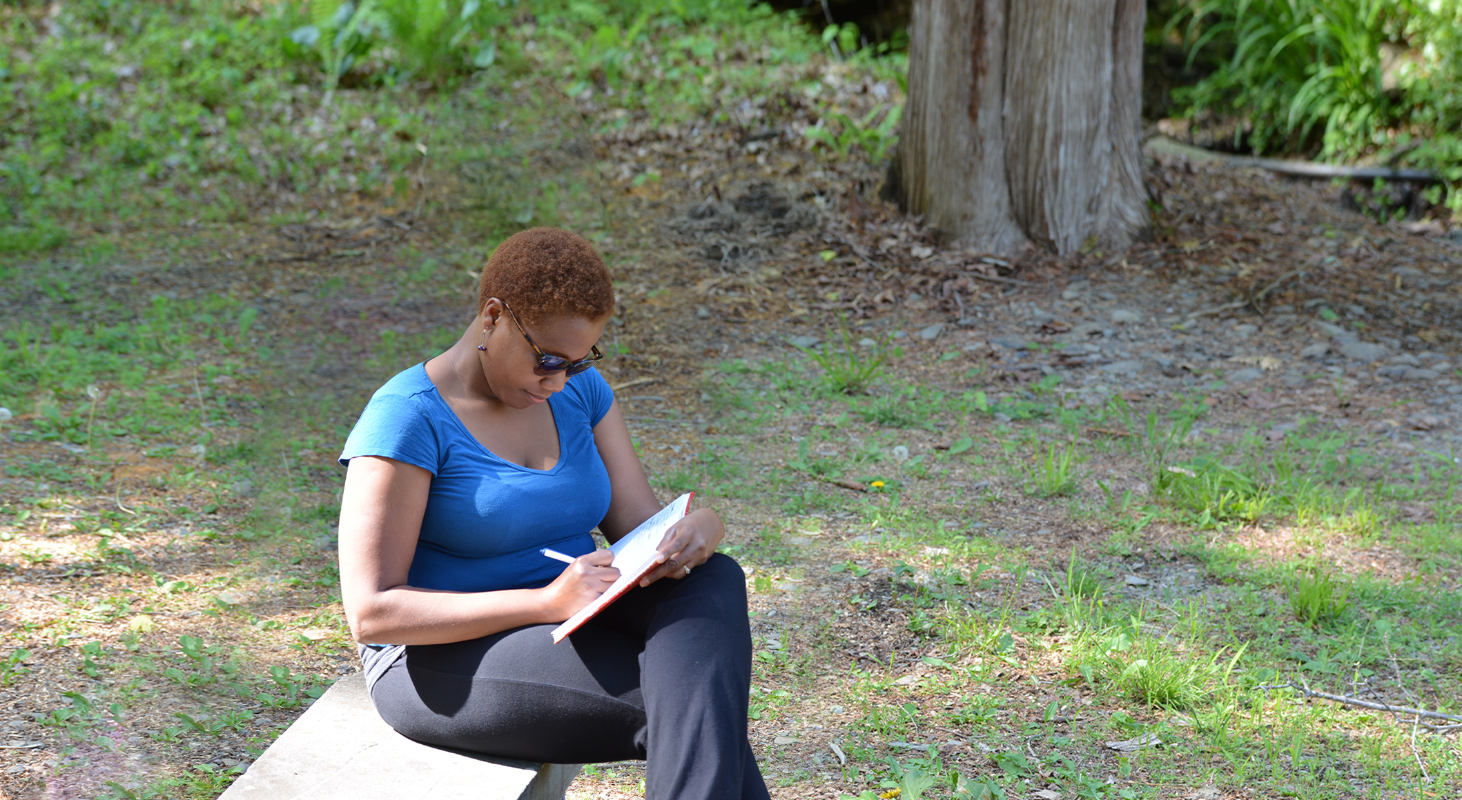 Omega participant journaling on campus