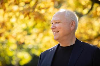 Max Strom against backdrop of autumn leaves