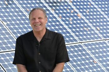 Skip Backus in front of OCSL solar panels