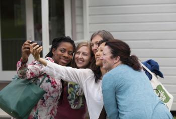 Women take a selfie together at Omega campus