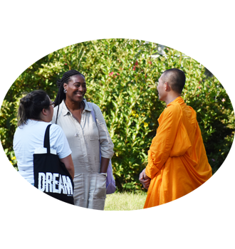 2 women talk with buddhist monk