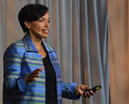 Bonnie St. John speaks on stage about leadership and resilience, inspiring audiences with her message of strength and recovery.