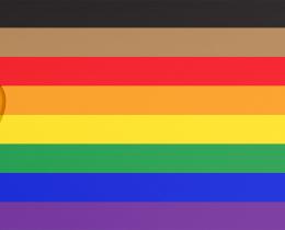 Heart on inclusive Pride flag background for LGBTQ+ Pride Month booklist.