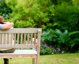 Couple sitting on a bench embracing in nature, symbolizing emotional healing and renewed intimacy after heartbreak.