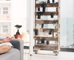 Woman practicing mindfulness meditation at home to support resilience, self-care, and stress reduction.