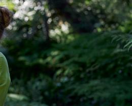 Woman practicing mindful breathing outdoors illustrating natural foot pain relief through breathwork, gentle movement, and holistic physical therapy practices