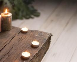 Sacred ritual altar with lit candles, smudging herbs, incense, and ceremonial tools arranged for meditation, spiritual practice, and healing retreat.