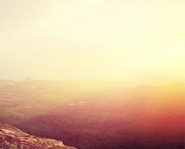 Woman standing on a mountain with her backpack