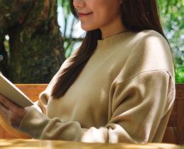 Person journaling outdoors in a peaceful garden setting during a writing for healing retreat focused on self-discovery, reflection, and creative expression.