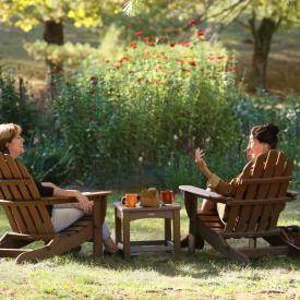 Friends enjoying the garden in Adirondack chairs