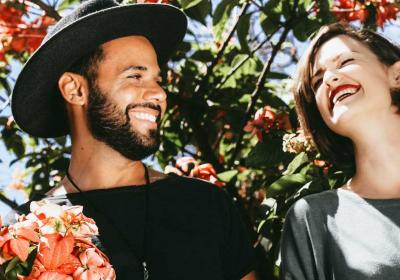 Man and woman laughing among flowers