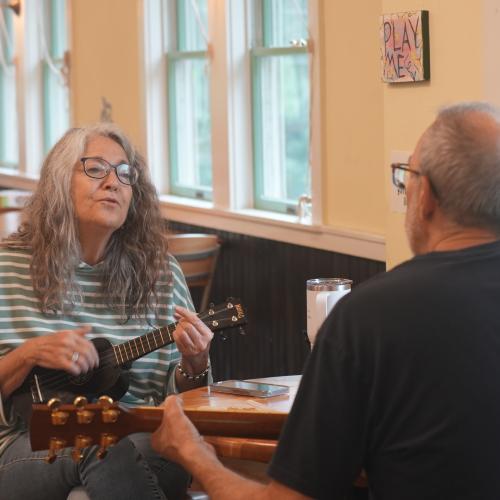 Cafe patrons playing musical instruments