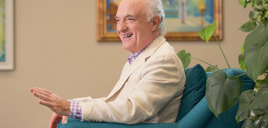 Dimitri Moraitis sitting in a chair speaking