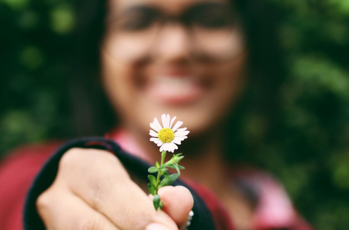 woman giving you a flower