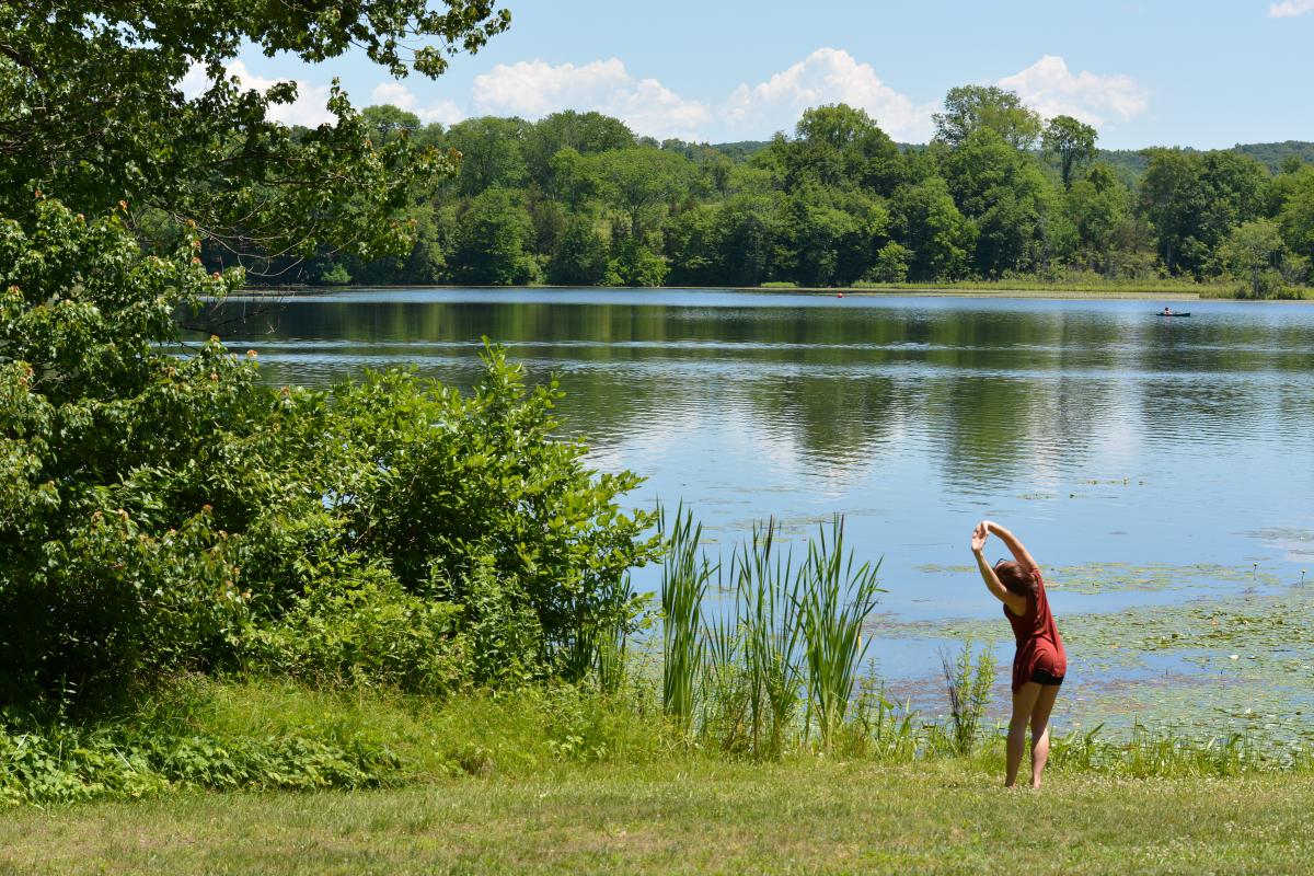 Person stretching on the lake shore