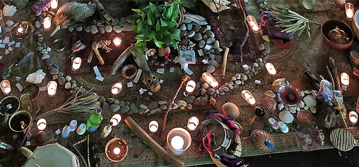 Shamanic reiki artifacts, including candles, on a table