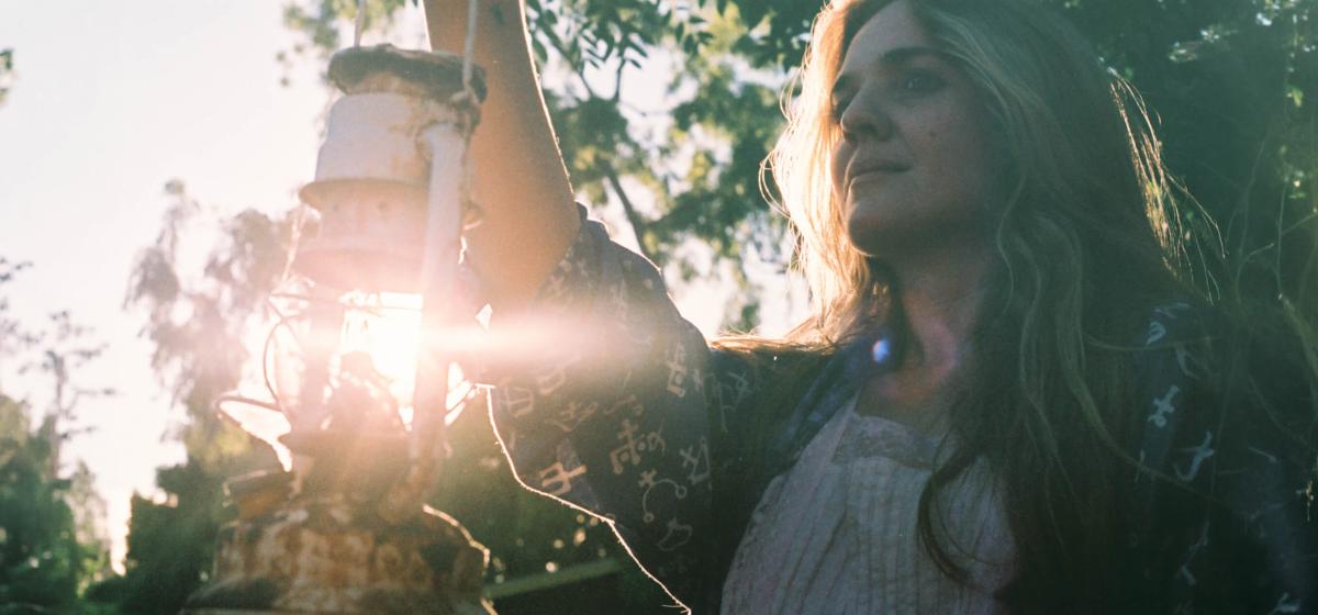 Eliza Swann holding up a lantern