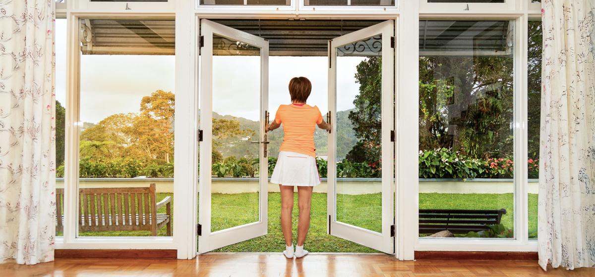 Woman opening the door and stepping outside