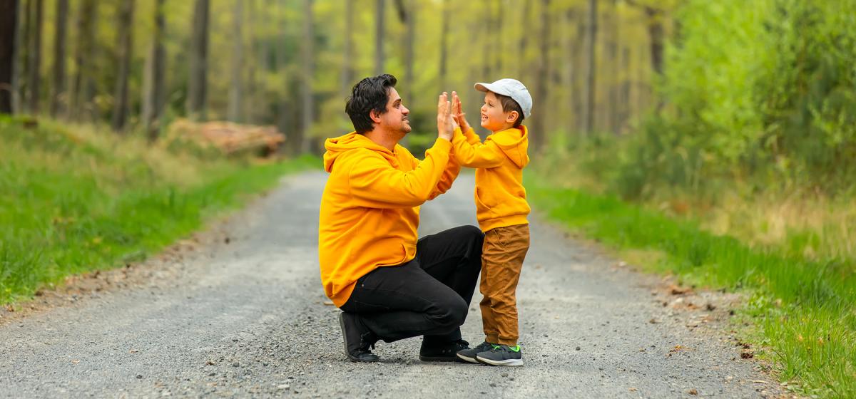 Father and child having a moment of connection on a trail