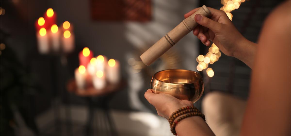 Sound healing with singing bowl and candles