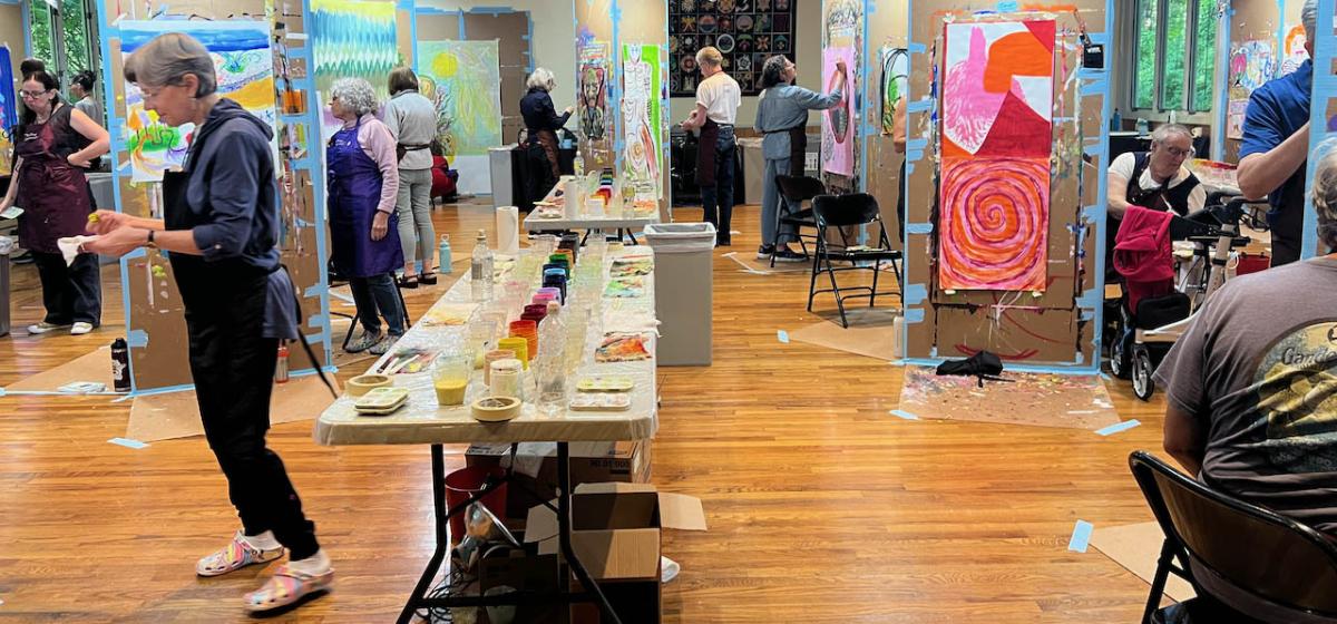 Group of participants at an Awakening the Creative workshop, making expressive paintings.