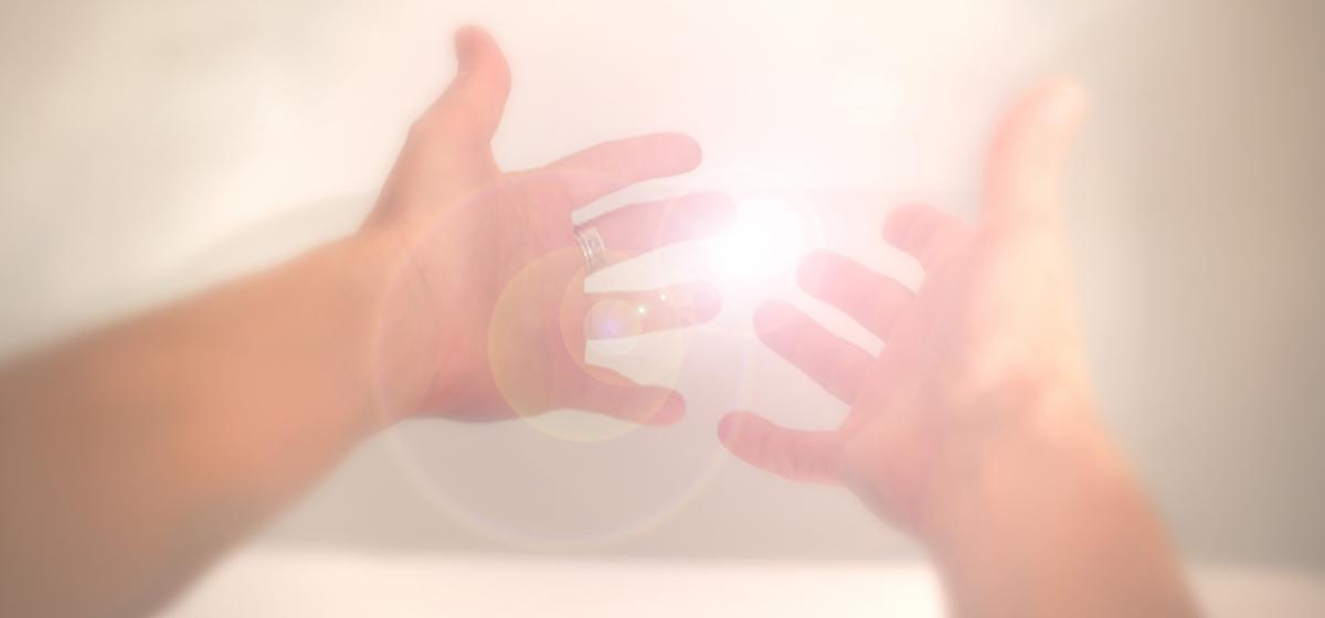 Hands reaching for light