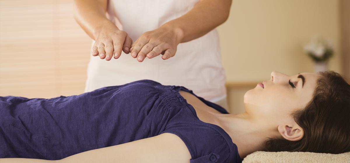 Woman receiving reiki treatment