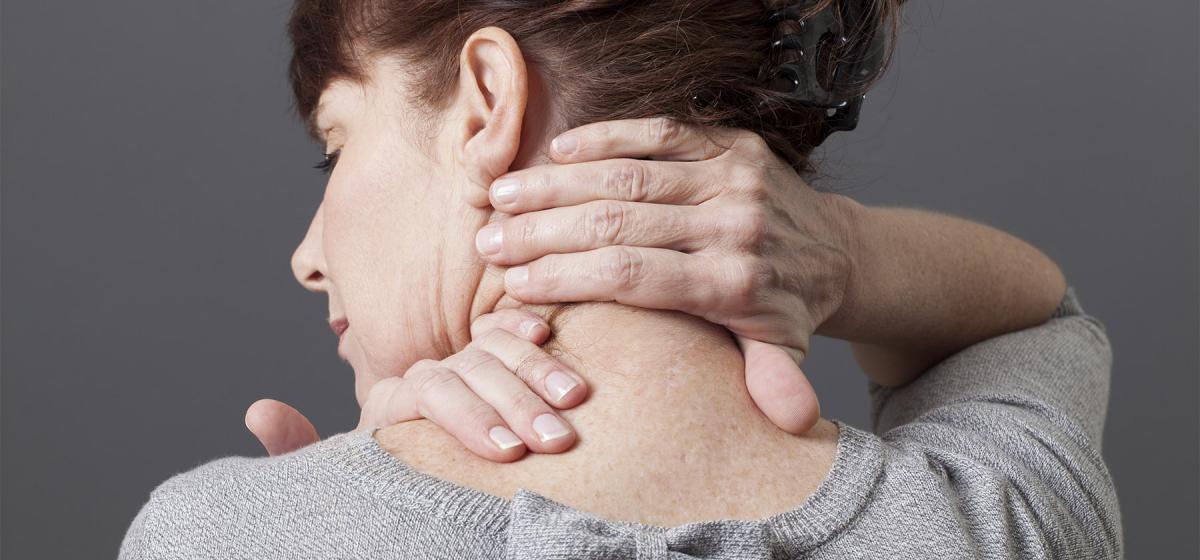 Person performing shiatsu on their own neck