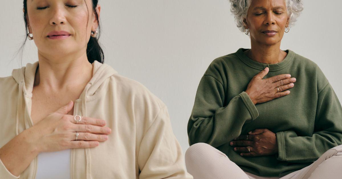 Two people meditating in a somatic BioMed practice