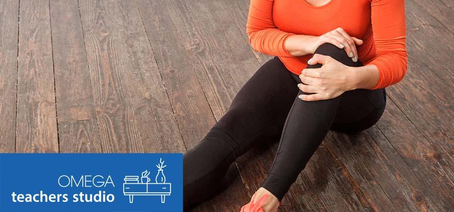 woman on the floor holding her knee