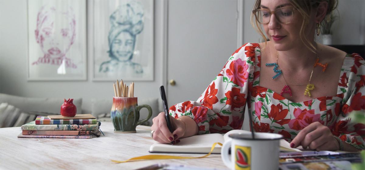 Mari Andrew at her desk drawing
