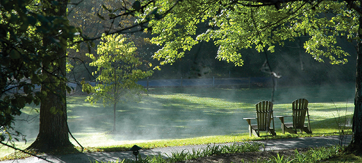 Adirondak chairs by misty lake