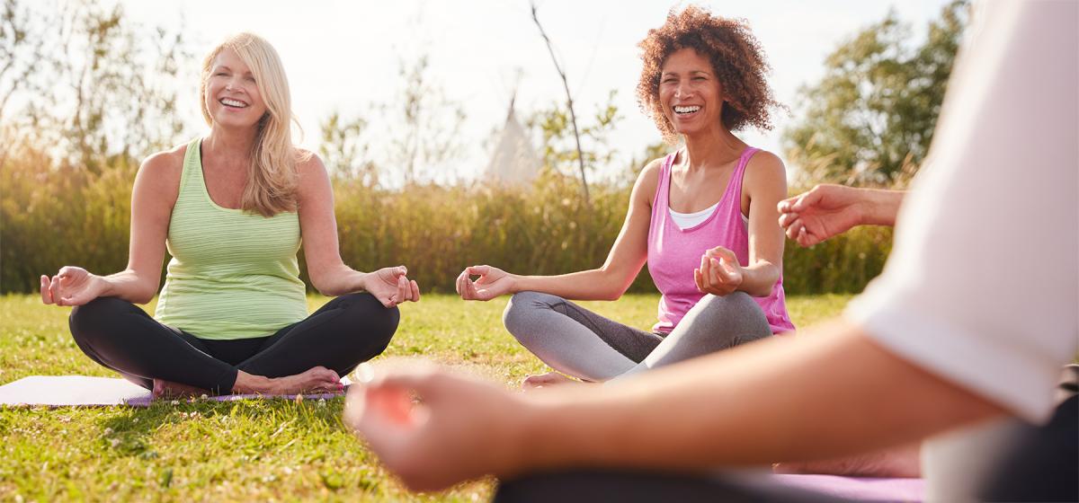 Group of people meditating together outside