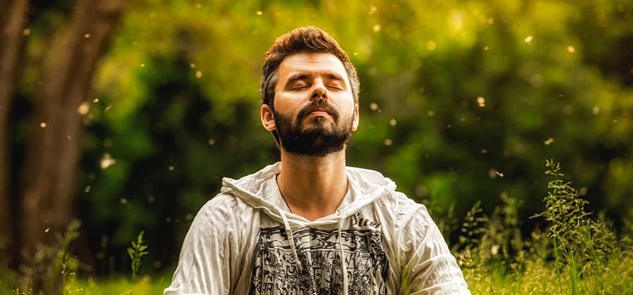 Man meditating in a field