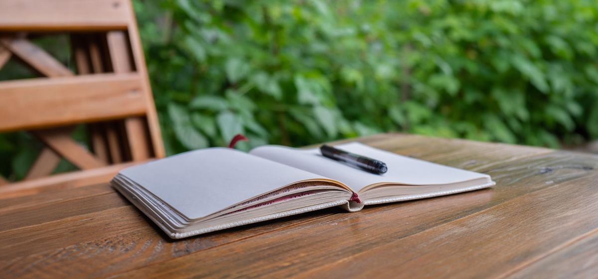 Open journal at a table in a garden, for someone to plan their life