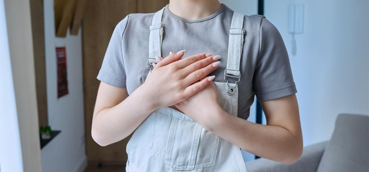 Woman with hands on her heart