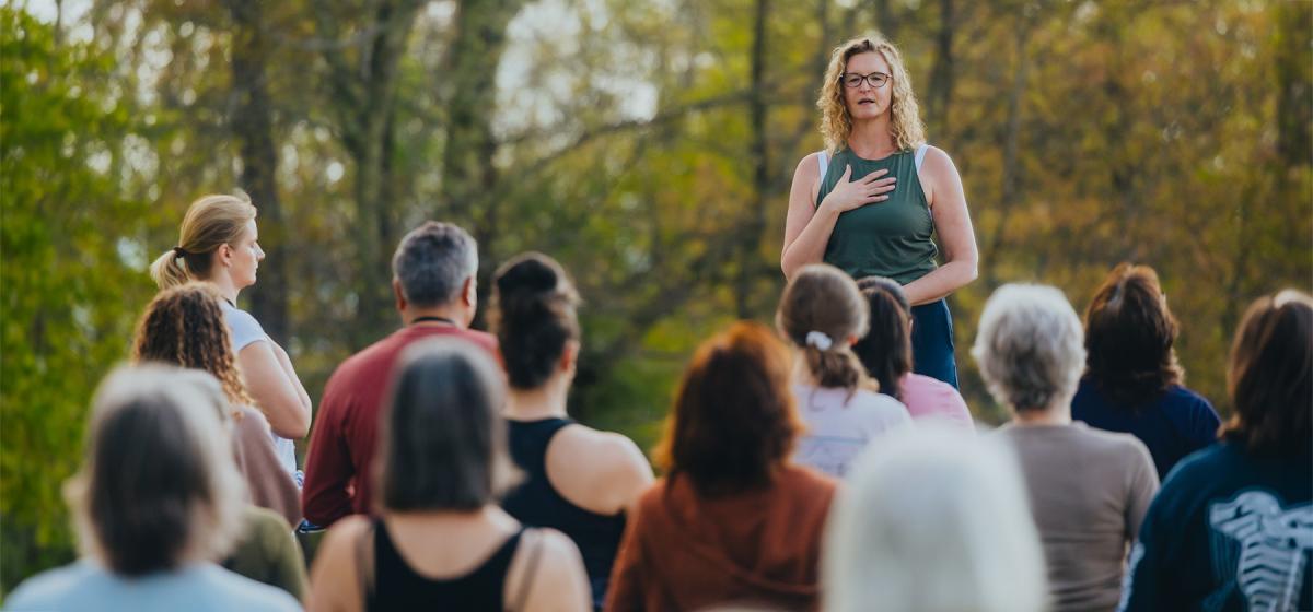 Sara Raymond leading a group in a mindfulness exercise