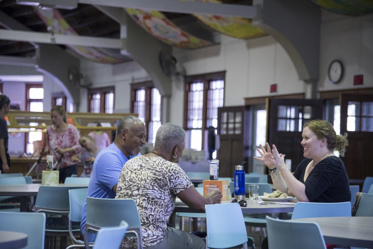 3 people enjoying a meal together in the Omega Dining Hall