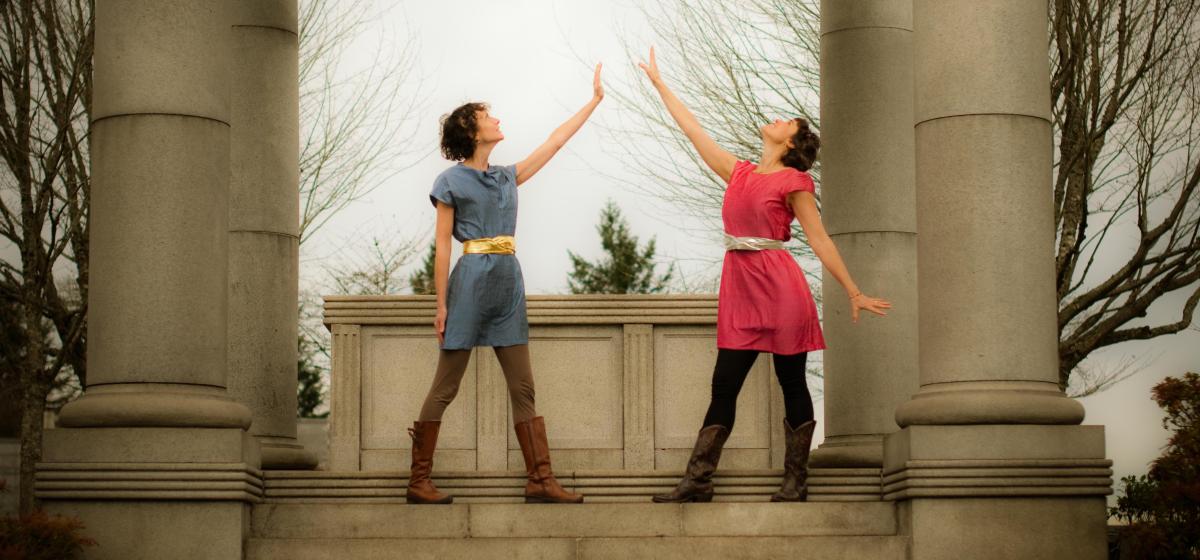 Katie Todd and Emily Trinkaus standing on a large stone step under an archway