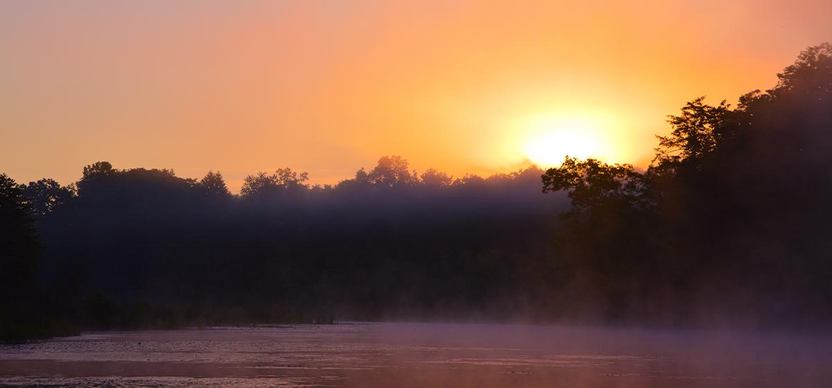 Mysterious sunrise over a lake