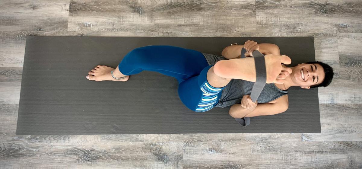 Pooja Virani stretching on a yoga mat