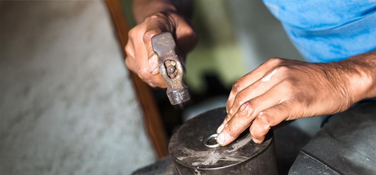 Person hammering a piece of silver into a ring