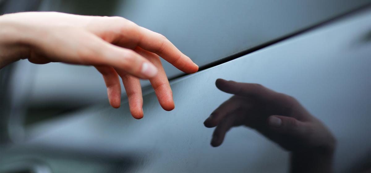 Hand touching its reflection