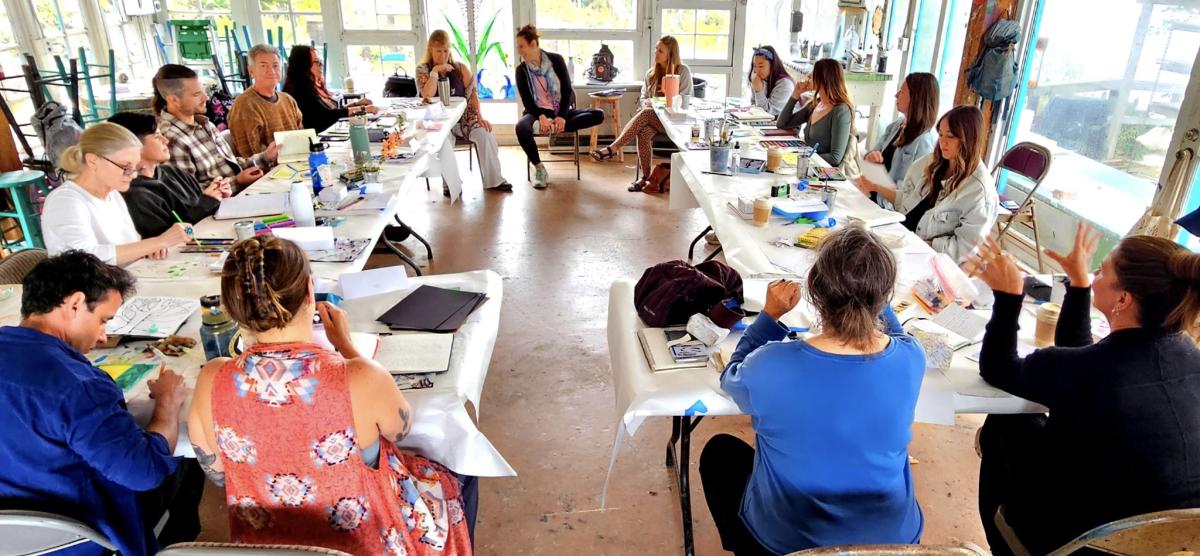 Group of people working on art projects at a Healing Through Creativity workshop
