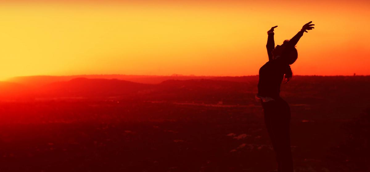 Person standing on top of a mountain