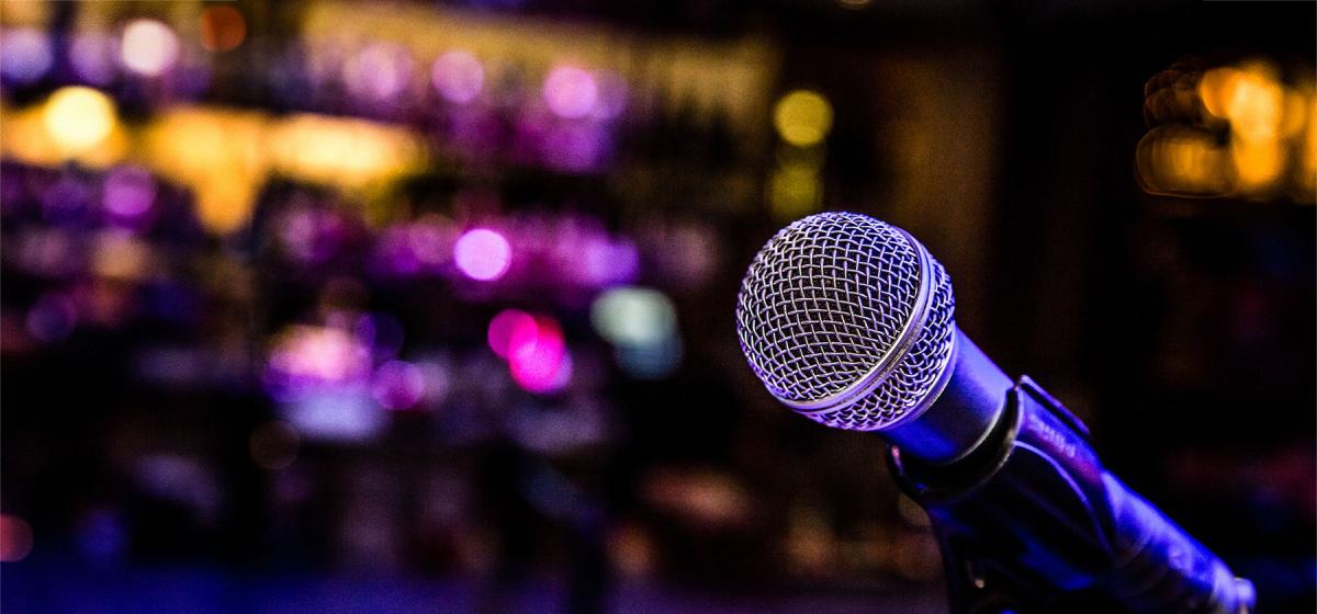 Microphone in front of a dimly lit comedy club