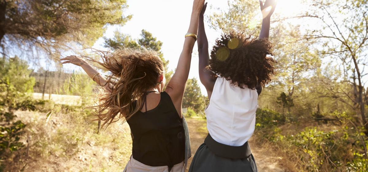 Women dancing joyfully in nature